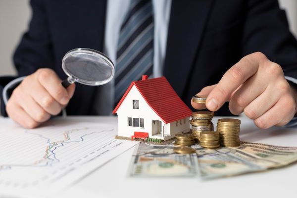 How do government policies influence the UK real estate finance sector?